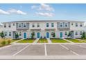 Charming two-story townhomes with blue front doors, well-manicured lawns, and reserved parking at 16606 San Nicola Pl, Lakewood Ranch, FL 34211