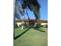 Well-kept backyard featuring lush lawn and tropical landscaping at 3314 Mcdill Rd # 3314, Bradenton, FL 34207