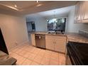 Bright kitchen with stainless steel appliances and a view through the window over the sink at 1007 Longfellow Cir, Sarasota, FL 34243