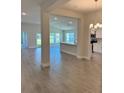 Bright, open-concept living room with tile flooring and a view into the modern kitchen at 2644 Averland Loop, North Port, FL 34287