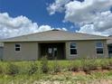 The home's exterior features a covered lanai and minimal landscaping in the backyard, offering a blank canvas at 2648 Averland Loop, North Port, FL 34287