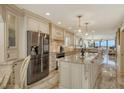 Modern kitchen with stainless steel appliances and a center island at 5740 Midnight Pass Rd # 307, Sarasota, FL 34242