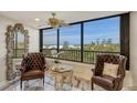 Comfortable seating area with beautiful views of the beach and ocean at 5740 Midnight Pass Rd # 307, Sarasota, FL 34242