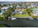 Stunning waterfront home with lush lawn, boat dock, and lift, offering direct access to the bay at 7056 Hawks Harbor Cir, Bradenton, FL 34207