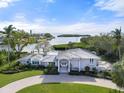 Beautiful waterfront home featuring manicured lawn and stunning bay views at 7056 Hawks Harbor Cir, Bradenton, FL 34207