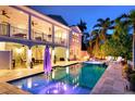 Inviting backyard pool with hot tub and outdoor seating area at 718 Key Royale Dr, Holmes Beach, FL 34217