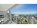 Expansive balcony view overlooking the marina and bay, featuring glass railings and outdoor seating at 101 S Gulfstream Ave # 16J, Sarasota, FL 34236