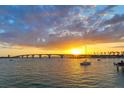 Scenic waterfront view at sunset, featuring a bridge and sailboats on the calm water at 101 S Gulfstream Ave # 16J, Sarasota, FL 34236