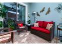 Relaxing patio with wicker furniture and colorful decor, perfect for outdoor living at 11728 Meadowgate Pl, Bradenton, FL 34211