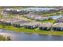 Panoramic aerial view of the houses showing the large lake and the community amenities at 25532 Royal Tern Ln, Englewood, FL 34223