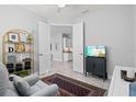 Living room with a comfortable chair, television, and a view to another room at 2722 Sapphire Blue Ln, Bradenton, FL 34211