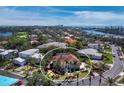 Attractive home with a red tile roof in a serene, green neighborhood with water views in the distance at 3540 Bayou Cir, Longboat Key, FL 34228