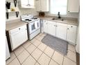 Functional kitchen with white cabinets, clean appliances, and ample counter space at 4444 Los Rios St, North Port, FL 34287