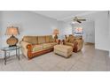 Cozy living room with neutral-toned furniture, tile flooring, and a ceiling fan at 5889 Canal Dr # I4, Bradenton, FL 34207
