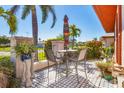 Cozy outdoor patio with dining set, privacy wall, and colorful umbrella at 6420 13Th Avenue W Dr, Bradenton, FL 34209