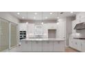 Bright kitchen featuring an island, stainless steel appliances, and ample cabinet space at 8024 Moonbeam Ave, Sarasota, FL 34241