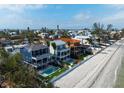 Beachfront homes showcasing coastal architecture, each with a private pool and backyard oasis at 915 N Shore Dr, Anna Maria, FL 34216