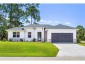 Charming single-story home featuring a well-manicured lawn and an attached two-car garage at 1342 Shaker Ln, North Port, FL 34286