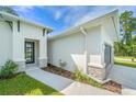 Stylish home with modern architecture, a welcoming walkway, and decorative stone accents enhancing the facade at 1342 Shaker Ln, North Port, FL 34286