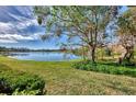Spacious backyard showcasing well-maintained lawn and serene lake view at 4914 Lakescene Pl, Sarasota, FL 34243