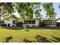 Expansive backyard featuring lush green grass and mature trees providing ample shade at 807 62Nd W St, Bradenton, FL 34209