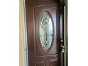 Elegant front door features decorative glass insert and dark wood finish at 3756 Lake Bayshore # 509, Bradenton, FL 34205