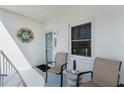 Comfortable balcony area with seating and sunny decor at 755 Village Cir # 203, Venice, FL 34292
