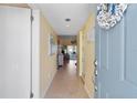Inviting entryway with neutral tones, tile flooring, and a glimpse into the living area at 755 Village Cir # 203, Venice, FL 34292