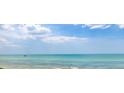 Beautiful ocean view featuring calm, turquoise water under a blue sky with scattered clouds at 7314 Point Of Rocks Rd, Sarasota, FL 34242