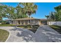 Charming single-story home with a circular driveway and well-manicured lawn, great curb appeal at 5445 Bahia Vista St, Sarasota, FL 34232
