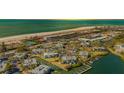 Stunning aerial view of a waterfront condo complex with a private beach and docks at 6750 Gulf Of Mexico Dr # 153, Longboat Key, FL 34228