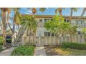 Charming two-story condo with a private entrance, mature trees and inviting curb appeal at 6750 Gulf Of Mexico Dr # 153, Longboat Key, FL 34228
