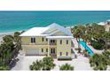 Stunning beach house with a metal roof, pool, palm trees, and beautiful beach at 777 N Manasota Key Rd, Englewood, FL 34223