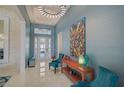 Bright foyer with high ceilings, modern lighting, and stylish decor creating an inviting entrance at 8261 Grande Shores Dr, Sarasota, FL 34240