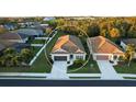 Charming one-story home with a well-maintained lawn and two-car garage, as well as lush landscaping at 176 Avens Dr, Nokomis, FL 34275