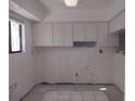 Image of a kitchen with white cabinets and new tile work at 1801 Gulf N Dr # 121, Bradenton Beach, FL 34217