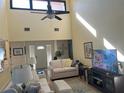 Bright living room with high ceilings and stylish furnishings, including a modern entertainment center at 4615 Hidden View Pl # 26, Sarasota, FL 34235