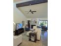 Bright living room features a fireplace, ceiling fan, and sliding glass doors to the outside at 4615 Hidden View Pl # 26, Sarasota, FL 34235