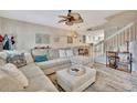 Inviting living room boasts an oversized sectional and open access to the kitchen and staircase at 5972 Giardino Ln, Sarasota, FL 34232