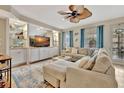 Living room with large sectional sofa, custom shelving, and serene decor at 5972 Giardino Ln, Sarasota, FL 34232