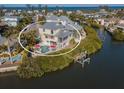 Waterfront home featuring a private pool, boat dock, and spacious outdoor entertaining areas at 114 Gull Dr, Anna Maria, FL 34216