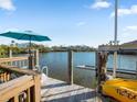 Waterfront home featuring a private dock with boat lift and sunny spot to relax at 114 Gull Dr, Anna Maria, FL 34216