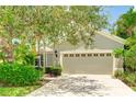 Inviting home with well-maintained landscaping and a spacious attached garage for convenient parking and storage at 11662 Old Cypress Cv, Parrish, FL 34219