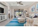 Bright living room showcases stylish decor, access to outdoor space, and tile flooring at 14369 Eagle Branch Dr, Nokomis, FL 34275