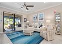 Inviting living room featuring neutral tones, comfortable seating, and view to screened patio at 14369 Eagle Branch Dr, Nokomis, FL 34275