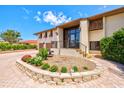 Lovely two-story home featuring lush landscaping and a brick driveway at 424 Cezanne Dr, Osprey, FL 34229