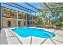 A private pool with glass screen showcasing a stunning garden in the background at 424 Cezanne Dr, Osprey, FL 34229