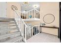 Bright, carpeted staircase featuring white railings and neutral walls at 424 Cezanne Dr, Osprey, FL 34229