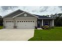 Charming single-Gathering home featuring a three-car garage and a well-manicured lawn at 6614 162Nd E Pl, Parrish, FL 34219