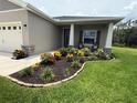 Well-manicured front yard with landscaping and colorful flowering shrubs, complete with a cozy sitting area at 6614 162Nd E Pl, Parrish, FL 34219
